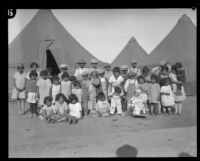 Group portrait of children outside tents after the flood resulting from the failure of the Saint Francis Dam, Santa Clara River Valley (Calif.), 1928