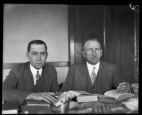 District Attorney Jess Hession and Judge William M. Dehy consulting books, Inyo County, 1927