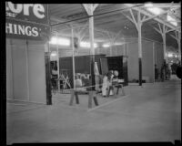 Business in temporary quarters in the Oil Equipment and Engineering Exposition hall after the Long Beach earthquake, Compton, 1933