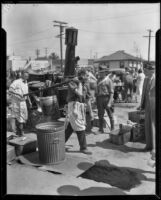 Aid workers carrying food at an outdoor kitchen after the Long Beach earthquake, Southern California, 1933
