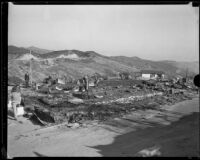 Men observe National Forest Inn ruins following fire, California, 1932