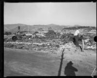 M. D. Martin, proprietor of the National Forest Inn, observes damage following a fire, California, 1932