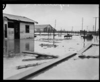 Storm-flooded open area with a barn in the background, [Lynwood?], 1927