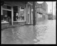 Rain-flooded commercial street, Compton, 1927