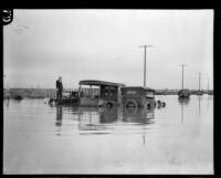 Automobiles in flood water at 11th and Vernon Avenues, los Angeles, 1927