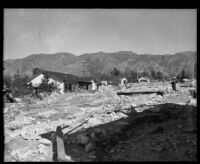 Boulder-strewn area in front of damaged houses after a catastrophic flood and mudslide, La Crescenta-Montrose, 1934