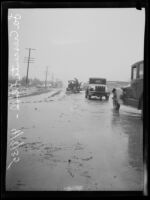 Workers clear flood debris from road after heavy rainfall, La Crescenta-Montrose, 1935