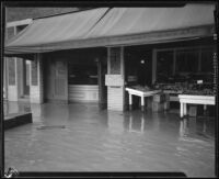 Produce store on a flooded street during or after a rainstorm, Los Angeles County, 1927