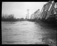 Center Street bridge spanning the San Gabriel River swollen with rainstorm flooding, Los Angeles County, 1927