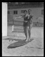 Brooks Gifford demonstrates aquaplane method to Mary Gifford, Hermosa Beach, 1935