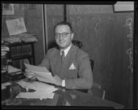 Charles Brown seated in his office after his return from a tour of Europe and Palestine, Los Angeles, 1935