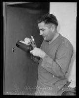 Detective Sergeant W. L. Woodruff dusting for fingerprints at the Gladys G. Fair crime scene, Long Beach, 1935