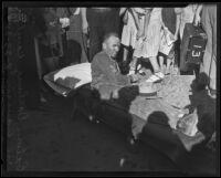 Calvin Darling, cave-in victim, reclining on an ambulance stretcher, 1935