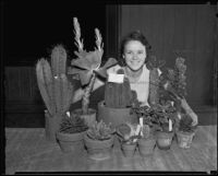 June Mayo with a collection of cacti at an exhibit of arts and crafts and hobbies, Los Angeles, 1935