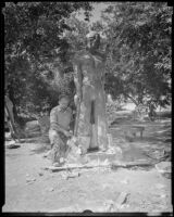John Palo-Kangas, sculptor, placing a mold on his plaster of Paris statue "Spirit of the C. C. C." in Griffith Park, Los Angeles, 1935