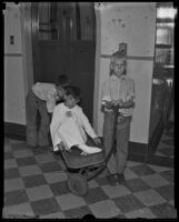 Raymond Nuno, who had an infection after stepping on a nail, and his brothers George and Javier who took him to the hospital in their wagon, Los Angeles, 1935