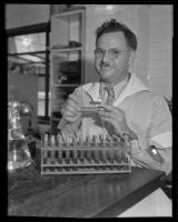 Dr. R. V. Stone holding test tubes, Los Angeles, 1935