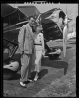 Bud Ernst and Lyda Roberti pose in front of a plane, Los Angeles, 1935