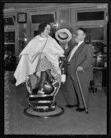 Vera Buss entertained by Gus Simon at a barbershop, Los Angeles, 1935