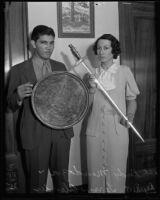 Deputy D.A. Terrys Olender and Rudy Mendoza holding sword and shield, Los Angeles, 1935