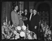 Fire Chief Ralph J. Scott receives a hand-illuminated book at a surprise party in his honor, Los Angeles, 1935