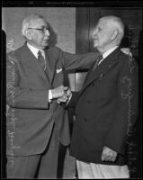 Dr. John Randolph Haynes (left) shaking hands with Robert Dominguez, Los Angeles City Clerk, 1935