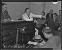 Lou Daro takes the witness stand in a crowded room, Los Angeles, 1935