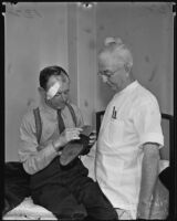 Nurse William Pearce tends to an injured Chas Whitney, Los Angeles vicinity, 1935