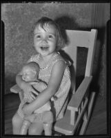 Barbara Lee Taber, runaway child, smiling with her doll, Los Angeles, 1935