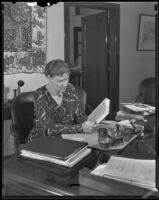 Althea Warren sitting at an office desk, 1935