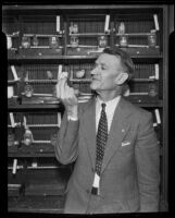 Howard Fogg, ornithologist and publisher, holding a roller canary, Los Angeles, 1935