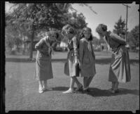 Girl Scouts looking in the grass, Los Angeles, 1935