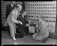 Postmaster H. B. R. Briggs, J. F. Bourne, Walter Brownsweiger, and an unidentified man by the P.O. boxes, Los Angeles, 1935