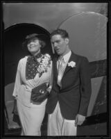 Russell J. Hardy and Madeline Bloomquist standing outside of the airplane they were married on, Santa Ana, 1935