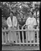 Mrs. Kraemer, Mrs. Goldstein, and Mrs. Davis stand behind a fence, Los Angeles, 1935