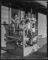 Part of the Talcott family standing on a porch: Marguerite, Peggy, Betty, Rodney Jr., Tom, Frank, 1935