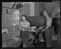 Freida Muller and Clarence R. Lionberger sorting mail, Los Angeles, 1935