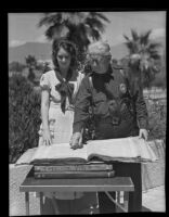 Chief George H. Fuller and Kathleen Wright look at copies of the Manila Freedom, San Fernando, 1935