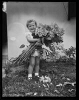 Eleanor Eula Carpenter smiling with dahlias, Long Beach, 1935