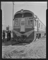 Some men admiring Santa Fe Railway's new diesel powered locomotive, Los Angeles, 1935