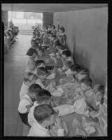 Students eating lunch on the first day back to school, Montebello, 1935
