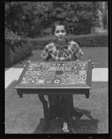 Betty Dore posing with inlaid table, Whittier, 1935