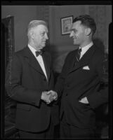 Robert L. Burns, president of the City Council of Los Angeles and R. M. Firth, New Zealand commissioner, shaking hands, Los Angeles, 1935