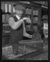 Tom Phelps cutting cigars in cigar shop, Los Angeles, 1935