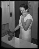 Mrs. Lawrence J. Swanson and her electric iron, Los Angeles, 1935