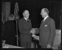 Ernest C. Moore shaking hands with Howard S. Dudley, Los Angeles, 1935
