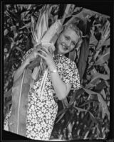 Cynthia Rickets poses with bushel of corn, Los Angeles, 1935