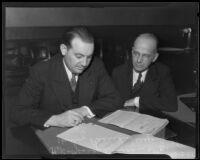 George A. Glover and Harry Pearson going over documents in embezzlement charge, Los Angeles, 1935