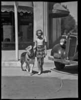 Wiggles helps Betty Lou Turner cross the street, San Fernando, 1935
