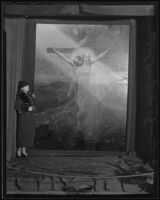 Mabel McClure standing by painting of Christ, Los Angeles, 1935